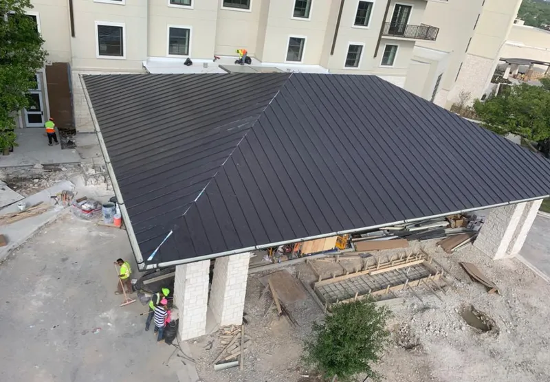 Metal roofing installation team working on a commercial building in Johnsburg